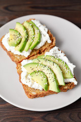 Variation of healthy toasts with avocado cream cheese and rye bread