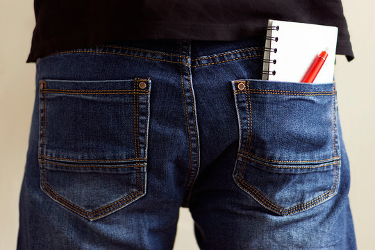 Notebook with pen in jeans pocket