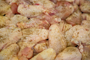 Fresh appetizing chicken wings fried on a kitchen gas stove