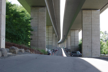 parking under the bridge in the city. Parking in the city, reinforced concrete structures of the overpass
