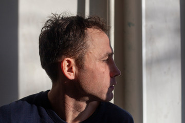 Portrait of a guy in the light from the window.