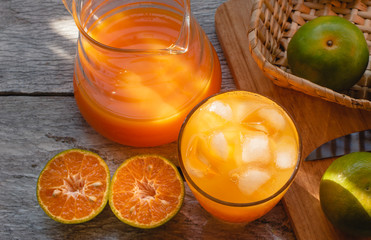Glass and Orange juice pitcher with oranges on the black wooden background, A refreshing drink Sweet taste from natural fruit High vitamin C. Helps the digestive system and nourishes the skin.