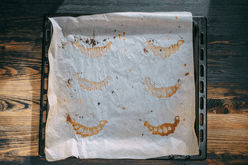 baking paper on a baking sheet with traces of baking croissants