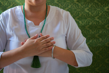 manos de mujer en posición mudra del corazón