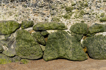 View at low tide. Close-up A foundation of huge cobblestones.
Fortification on the seashore.