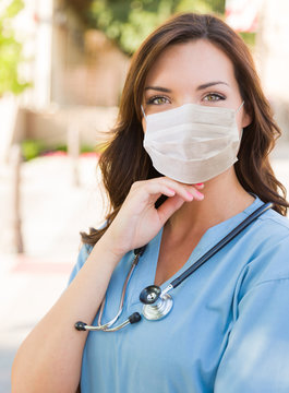 Female Doctor Or Nurse Wearing Protective Face Mask