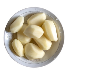 Fototapeta na wymiar Raw peeled potatoes in a plate on a white background