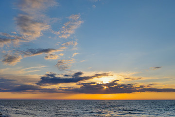 Beautiful sunset in blue and orange over a calm sea.