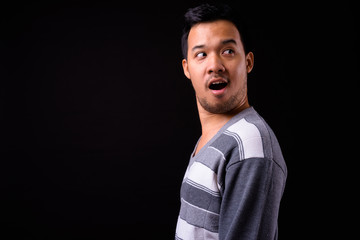 Obraz premium Rear view of shocked young Asian man looking back