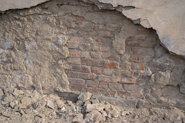Destruction of a house wall to a brick