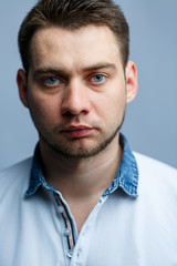 Obraz premium Closeup portrait of a man in a white polo on a white background. Male image for every day. Stylish guy