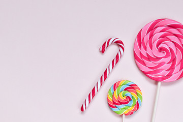Three bright juicy multicolored candies of different shapes