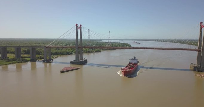 Freighter ship sails along the river Parana, parana river that crosses argentina and brazil.
