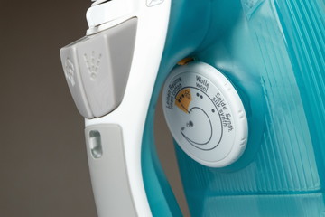 temperature control on the body of the turquoise iron close up