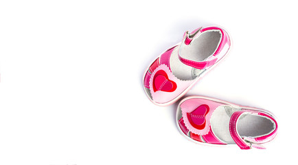 Children's shoes with a red heart. Isolated on white background.