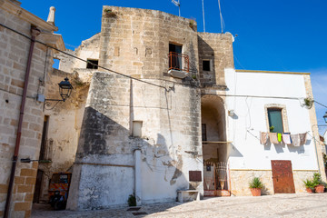 Fototapeta na wymiar Via Chiesa, Chiesa Street or Church Street sunny view in Laterza, Apulia Region, Province of Taranto