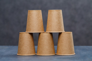 Paper cups for drinking, dishes. Disposable cardboard dishes made from environmentally friendly materials. Doesn't clog nature Eco-friendly, disposable, reusable, compostable dishes.