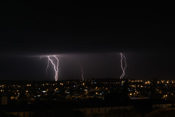 lightning and storm over the city two lights