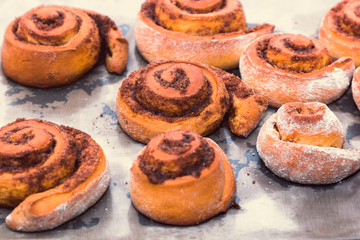rolled bread rolls with sugar and cinnamon baked in a home kitchen as an example of home cooking