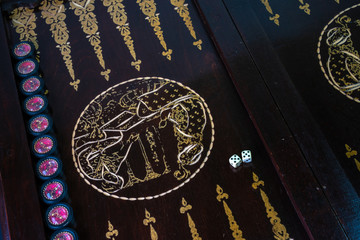 Backgammon game on a handmade board. Start of the game.
