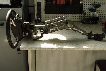 The car steering column assembly is on the desktop.