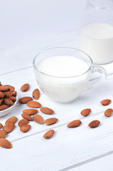 Almond milk in cup on white background