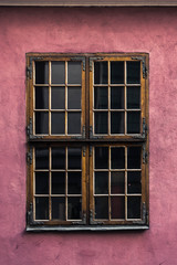 old wooden window on a pink wall