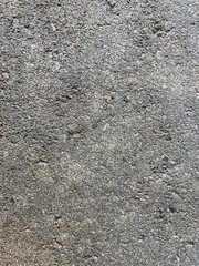 Close up photo of pitted concrete or cement. Background wallpaper or texture. Grunge or industrial.