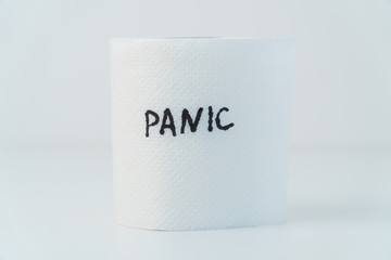 Toilet paper with text panic. Concept of lack of toilet paper in stores due to coronavirus, Covid-19, hygiene, panic