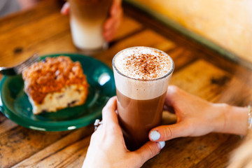 woman with iced latte and pastry