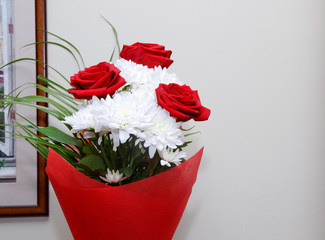 bouquet of red roses and white flowers. red packaging.