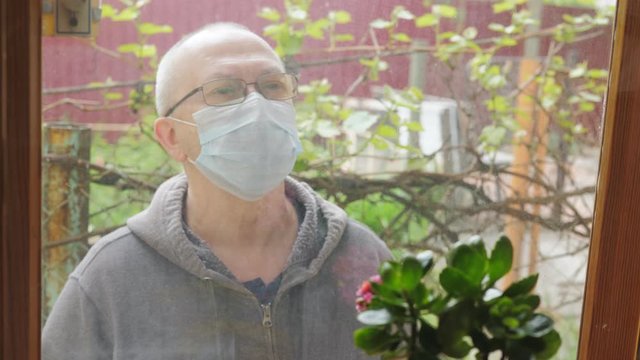 A mature man following the social distancing mandate issued due to COVID19 by now entering the home of a high risk elderly relative he wants to visit