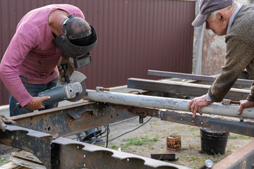 Metal workers use manual labor. Skilled welde. Factory workers making OT