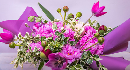 Fresh, lush bouquet of colorful flowers. Flowers frame on white wooden background. Top view with copy space.