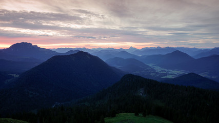 Naklejka na ściany i meble Mountain silhouettes layers of the Bavarian Alps during sunrise from Jochberg Walchensee, Bavaria Germany.