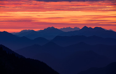 Mountain silhouettes layers of the Bavarian Alps during sunrise from Jochberg Walchensee, Bavaria Germany.