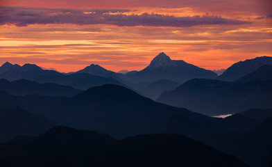 Mountain silhouettes layers of the Bavarian Alps during sunrise from Jochberg Walchensee, Bavaria Germany.