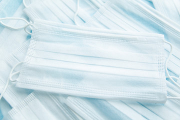 White protective medical mask close-up on the background of other masks