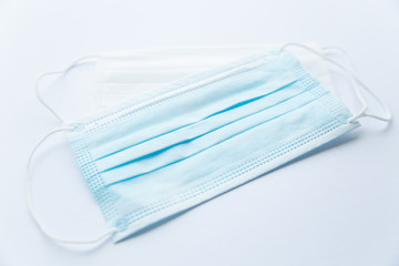 White and blue protective medical mask on a white background personal protective Equipment