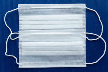 White masks on a dark blue background in the center.
