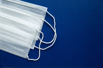 White masks on a dark blue background on the left.Empty background for notes on the right