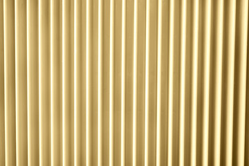 Close up of a radiator in sunlight yellow trendy color. Abstract pastel geometric background.