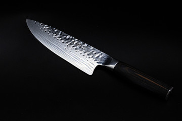 Japanese damascus kitchen knife on black background © Szabina