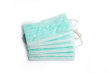 several surgical protective masks on top of each other, isolate on white