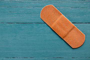 Single Adhesive Bandage on Turquoise Background