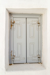 old wooden white door on a white wall