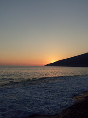 Naklejka na ściany i meble Sunset on the black sea. Black, red, orange colours. Beach, sky, sea. Photo taken in summer on vacation.