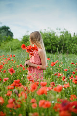 Naklejka na ściany i meble Ukrainian Beautiful girl in poppies field and wheat. outdoor portrait. Child collecting poppies and cornflower in summer field. Blooming Poppies memory symbol.