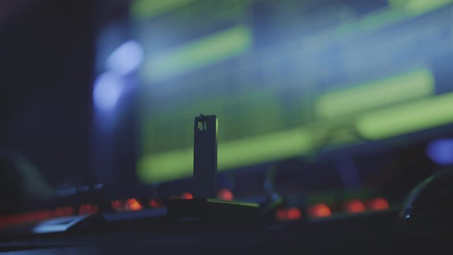 Close up of unrecognizable person hand connecting USB flash drive to the computer in dark computer club