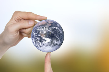 Globe in the hands. Elements of this image furnished by NASA
